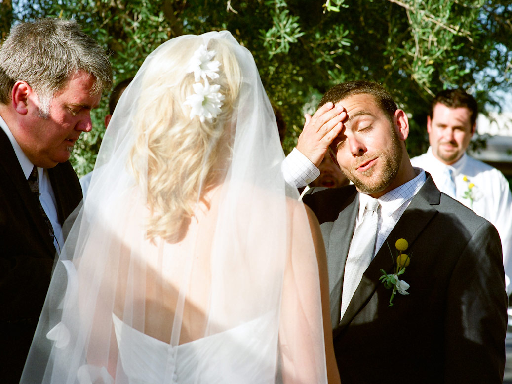 groom wipes sweat from forehead during palm springs summer wedding
