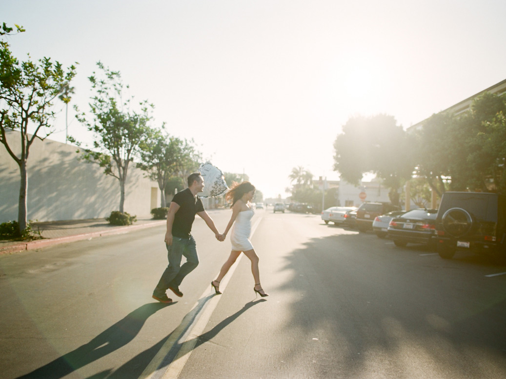 couple run across street during la jolla elopement shoot