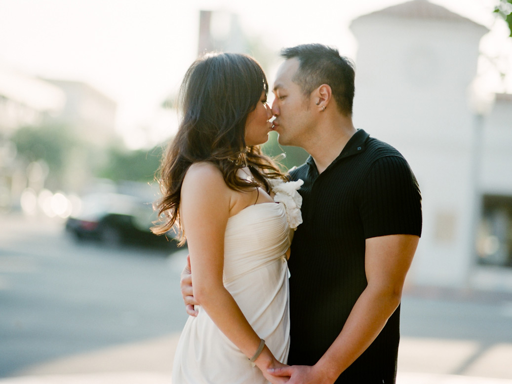 couple share kiss on street corner during downtown la jolla elopement shoot