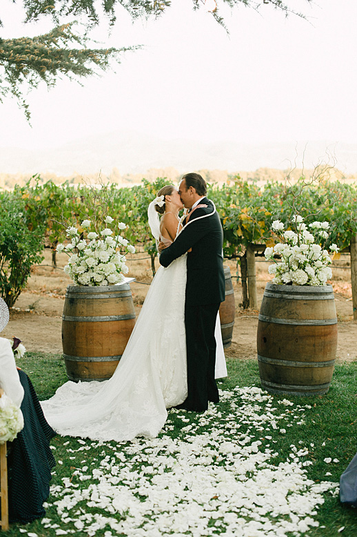 bride and groom kiss andretti winery wedding