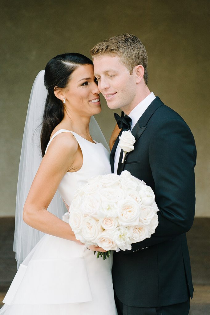 bride and groom embrace before san diego museum of art wedding