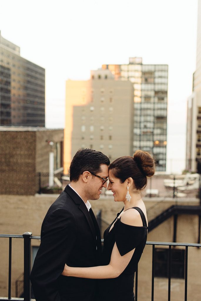 bride and groom posing in fire escape rooftop rafaello hotel