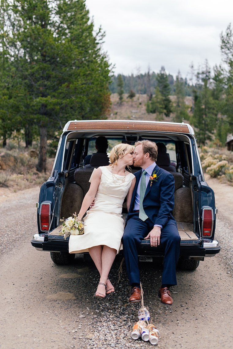 bride groom kiss tailgate vintage jeep wagoneer idaho rocky mountain ranch