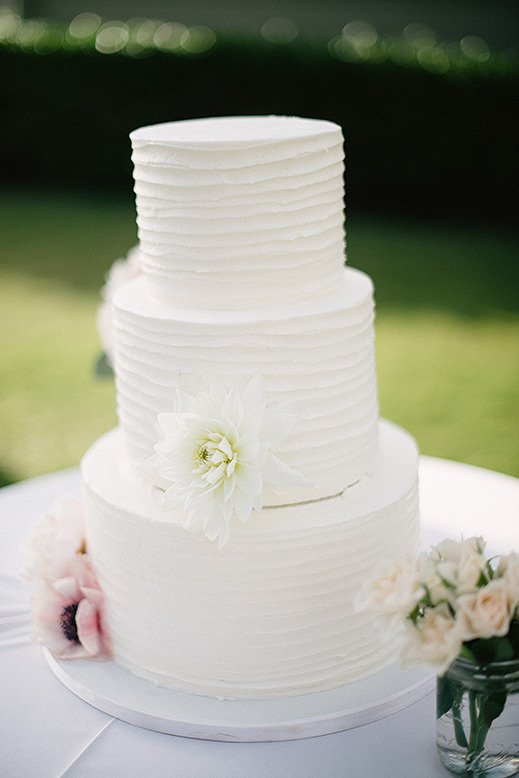 white three tier wedding cake with dahlia