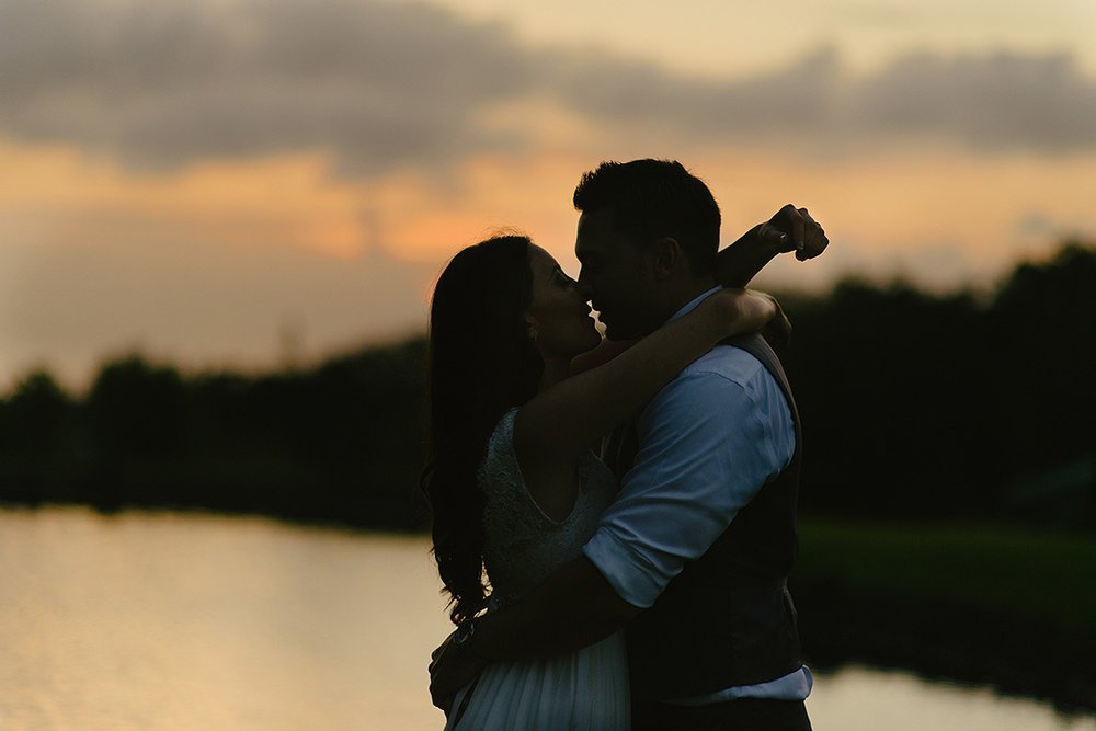 couple embrace at sunset during sunset ranch hawaii wedding