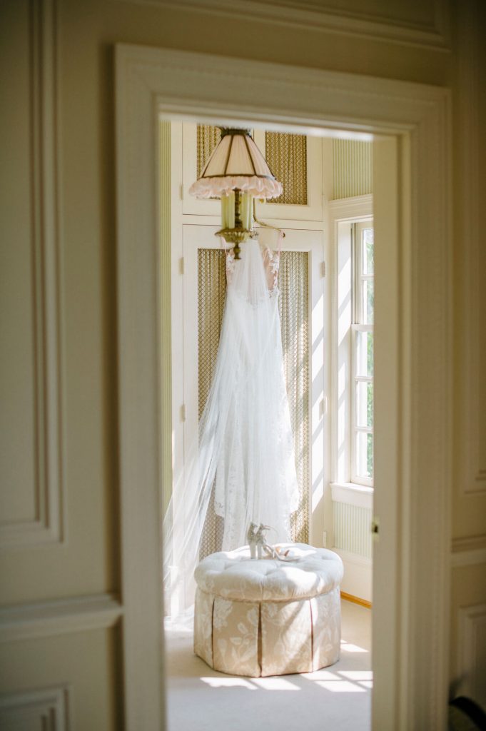 brides gown and shoes in bridal suite at great marsh estate wedding