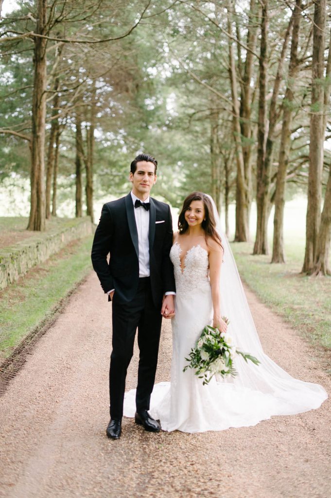 bride and groom pose on driveway at great marsh estate