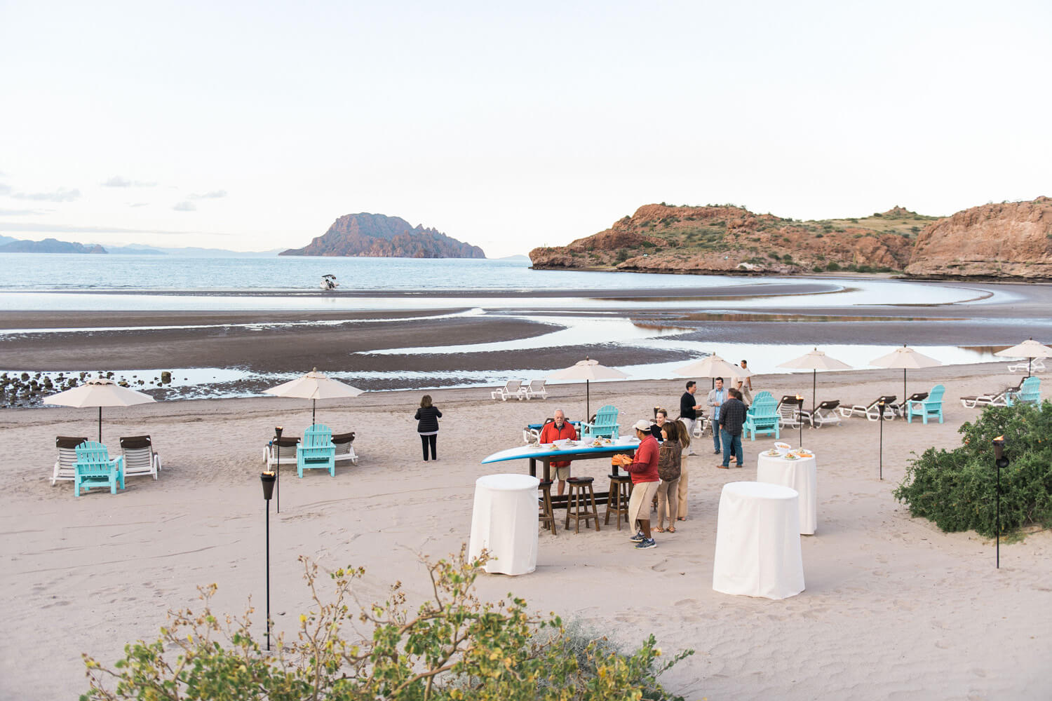 beach chairs tables umbrellas villa del palmar wedding welcome reception ensenada blanca