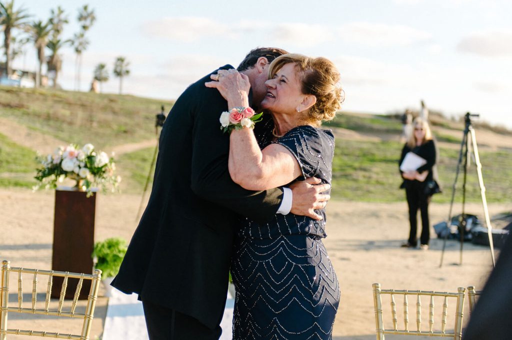 groom mother hug sunset cliffs intimate wedding