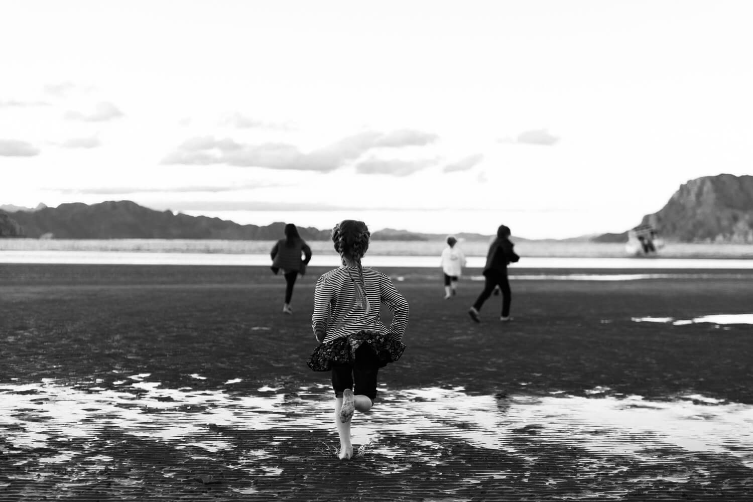 children run on beach at ensenada blanca mexico