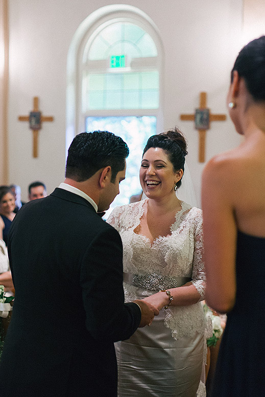 bride laughs during catholic church wedding