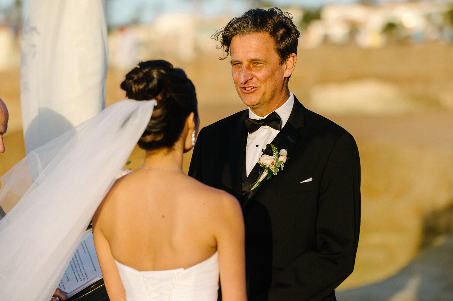 groom smiles vows sunset cliffs intimate wedding