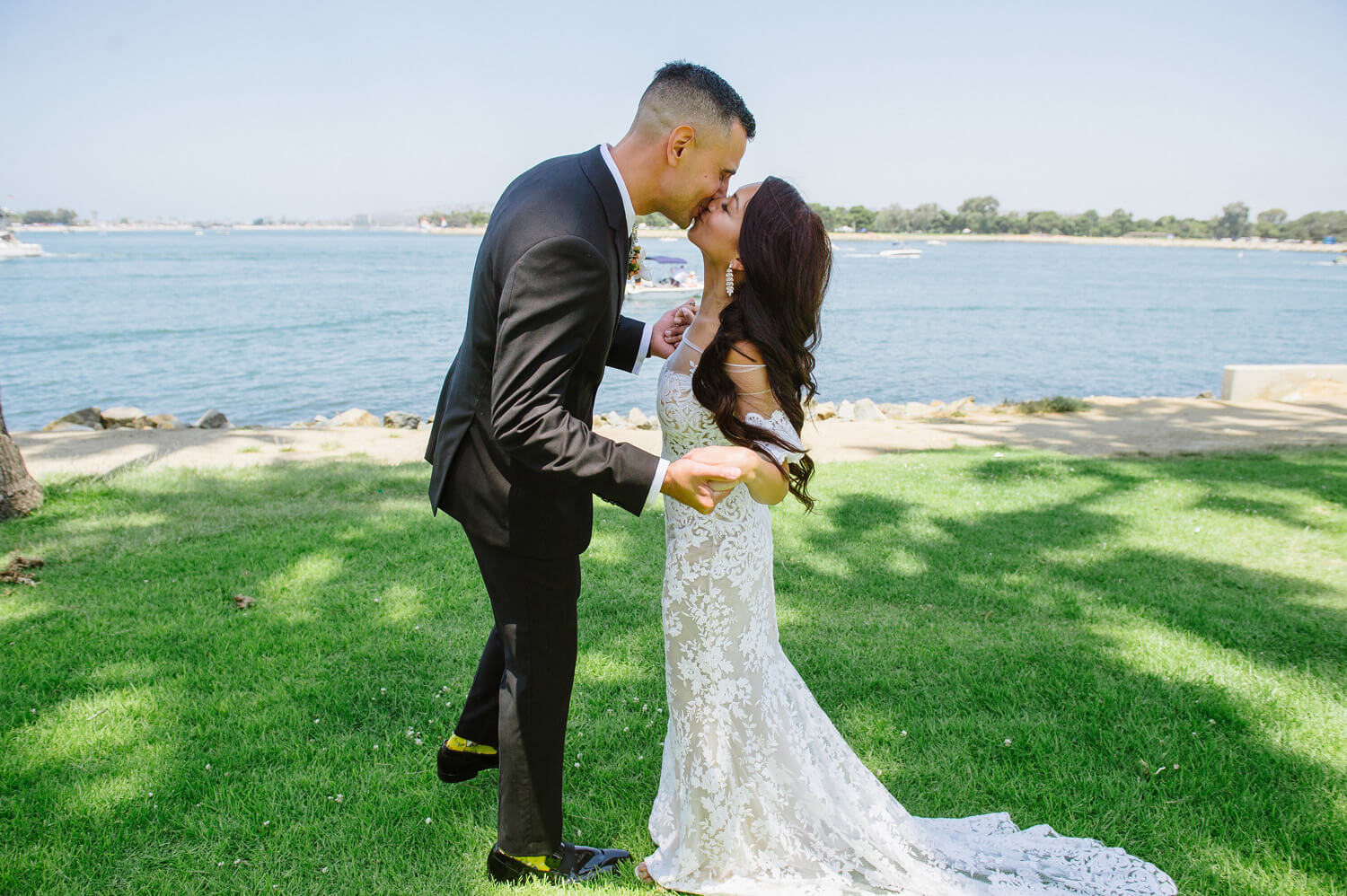 bride and groom kiss during first look at dana mission bay
