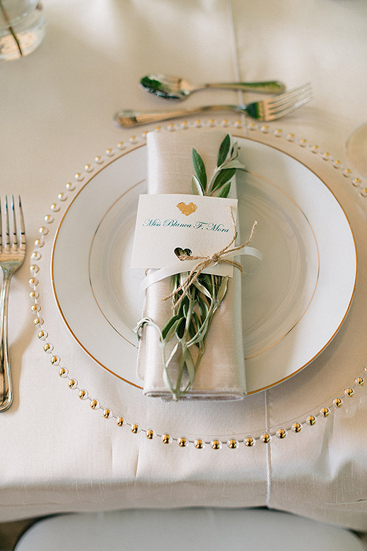 place setting with olive branch at wedding reception