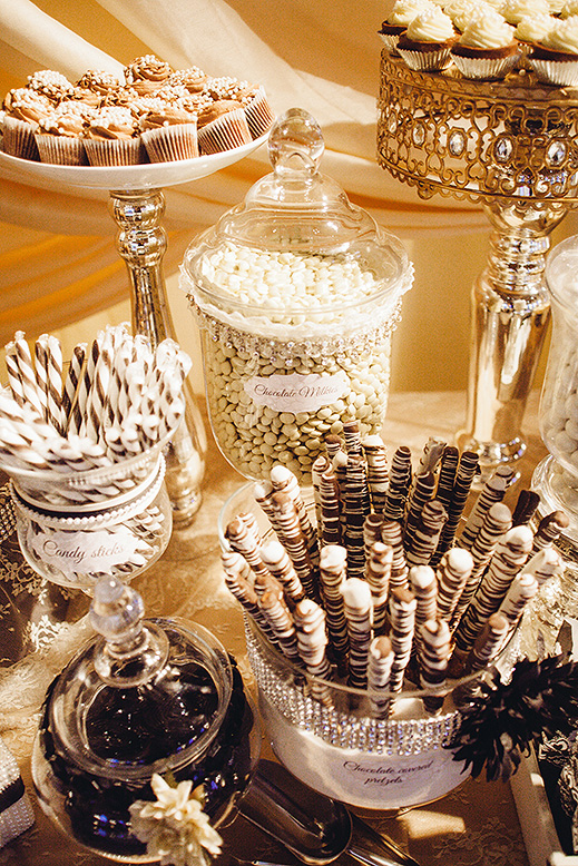 elegant candy table with glass containers of sweets