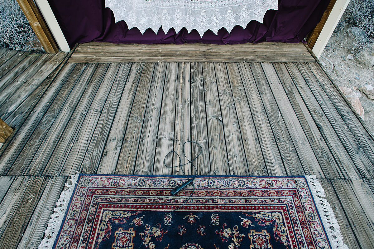 microphone and cord lay on persian rug atop stage before borrego springs wedding
