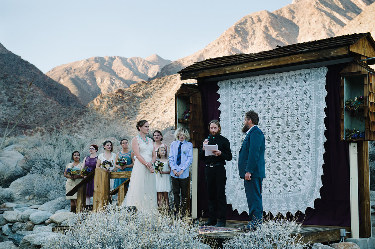 bride and groom listen to officiant during borrego springs wedding ceremony