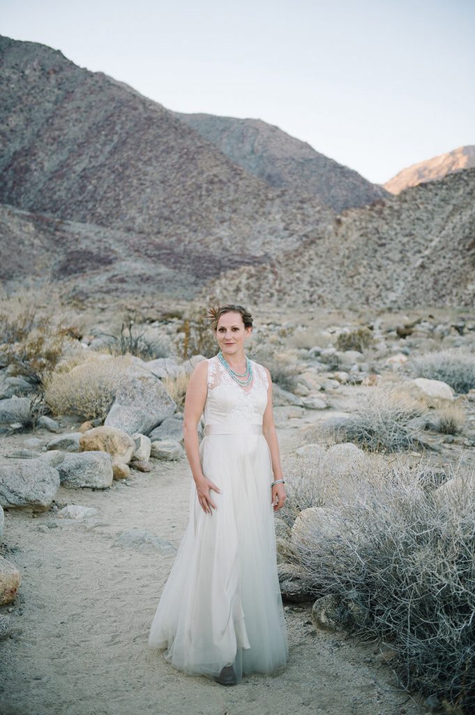bride in wedding gown and cowboy boots for desert wedding
