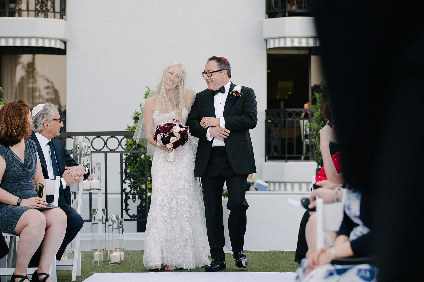 bride and her father smile as they walk down the aisle at london west hollywood