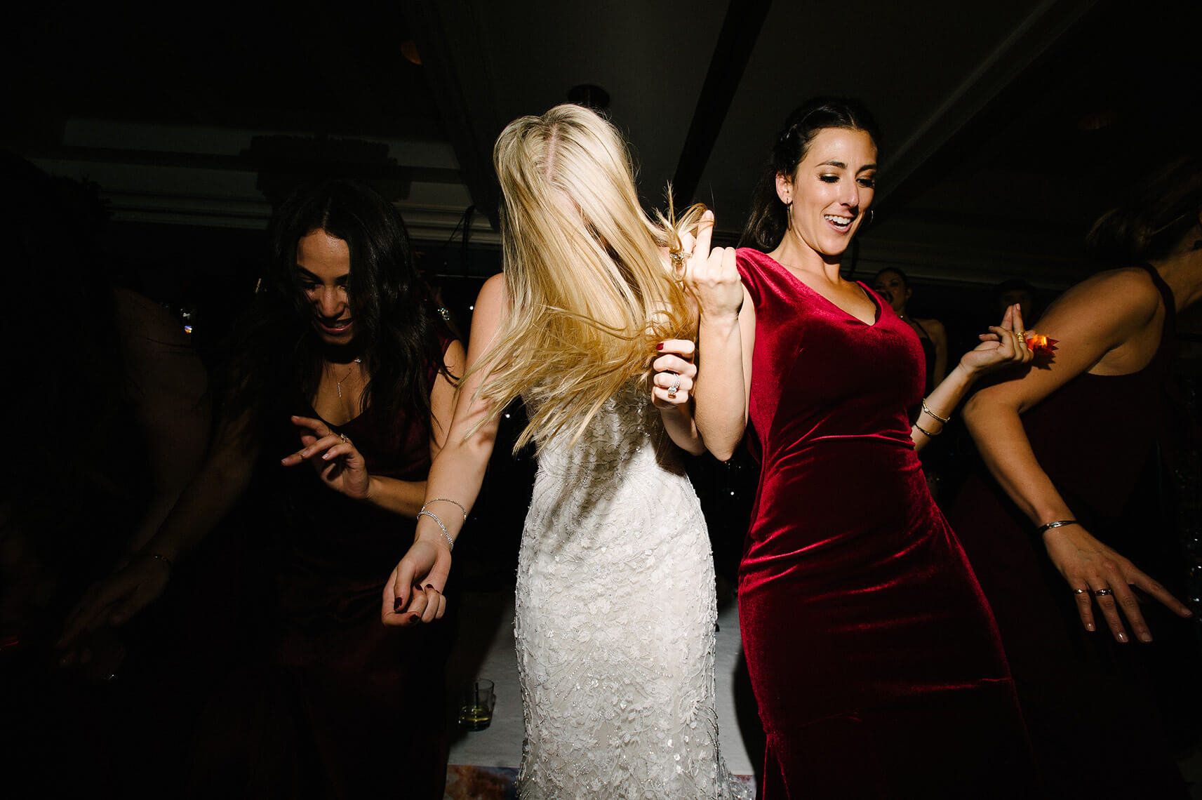 bride and bridesmaids dance during wedding reception