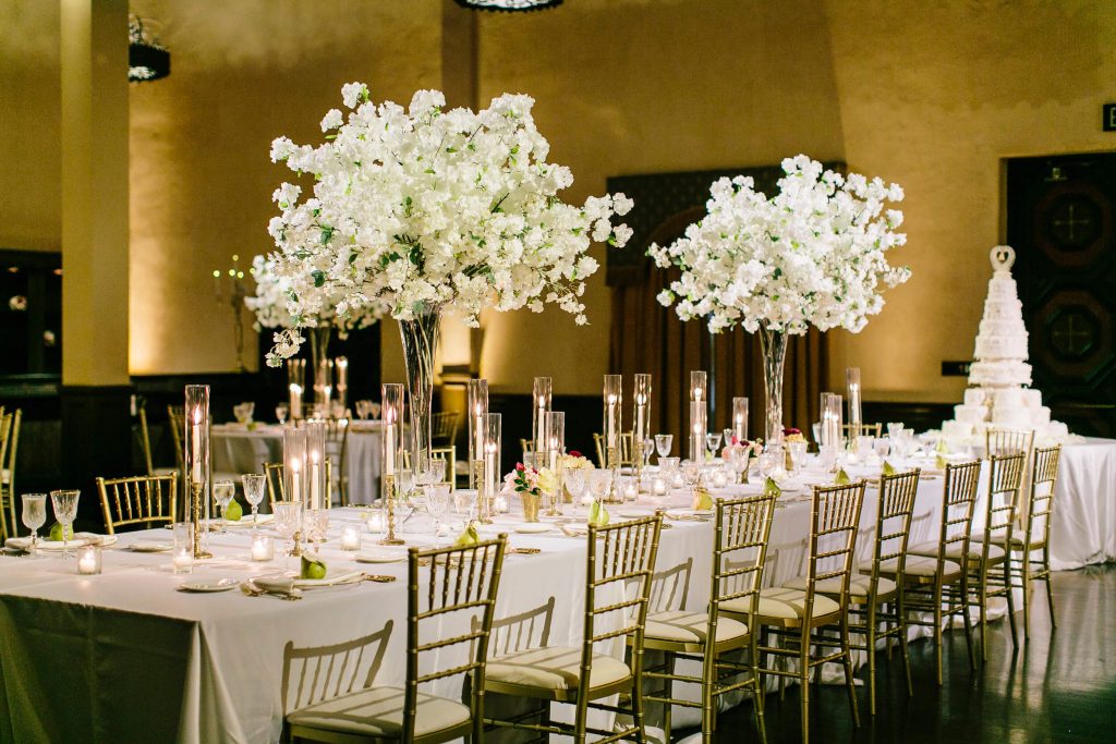 white flowers in hurricane vases gold chiavari chairs long table royal family inspired wedding prado balboa park