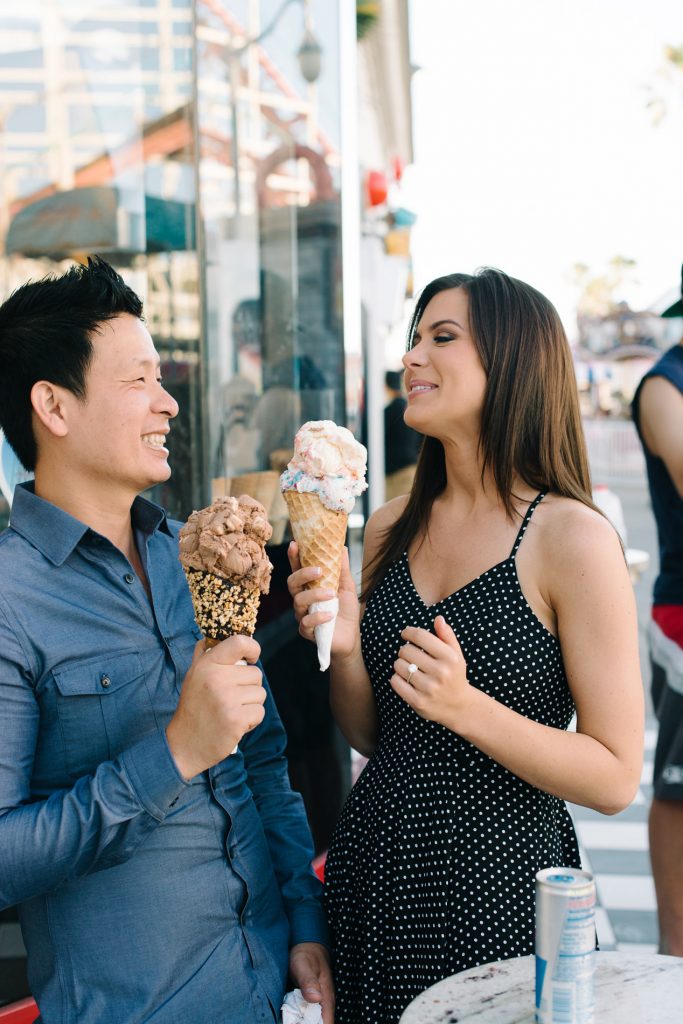 couple eating large ice cream cones belmont park engagement session