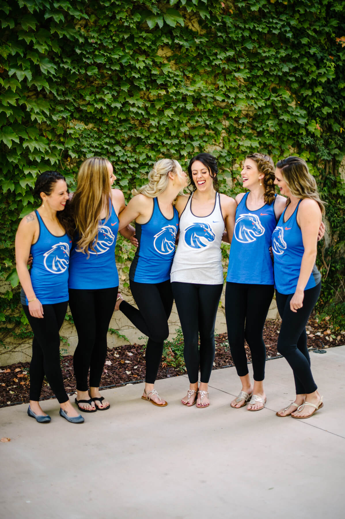 bride and bridesmaids wear boise state university tank tops