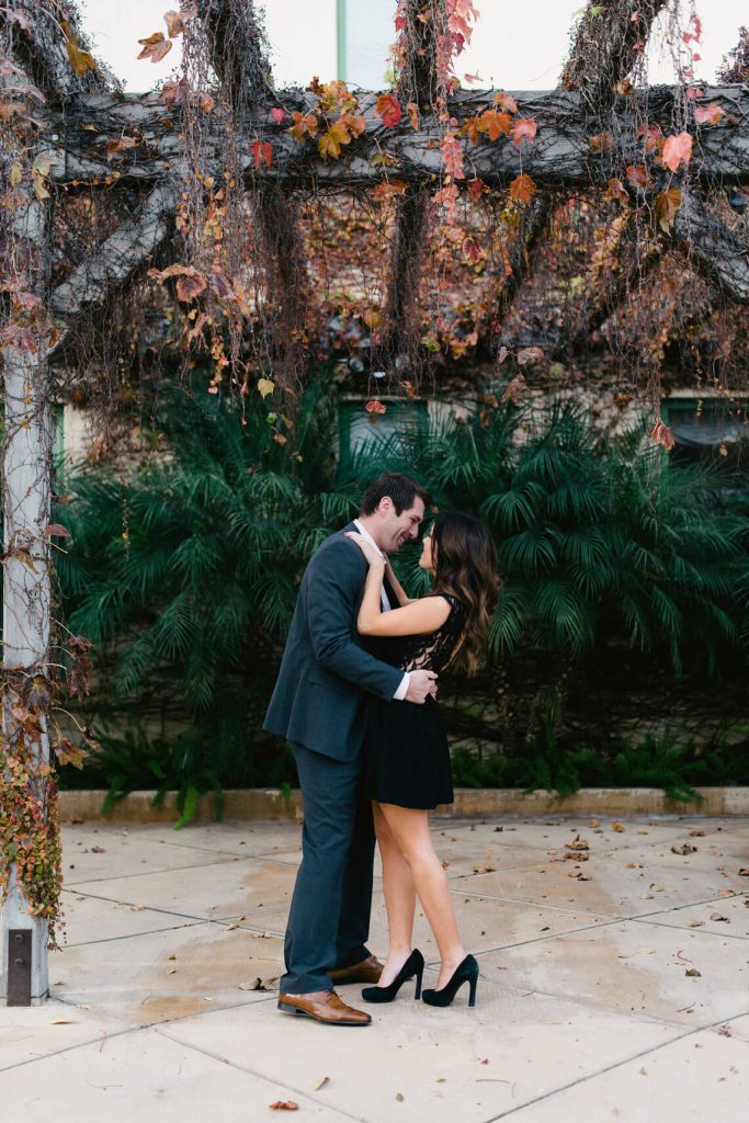 couple kissing under ivy pergola venice canals engagement photo