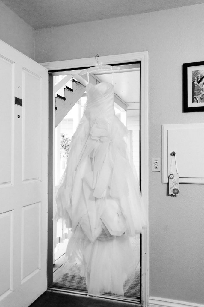 vera wang dress hanging in doorway