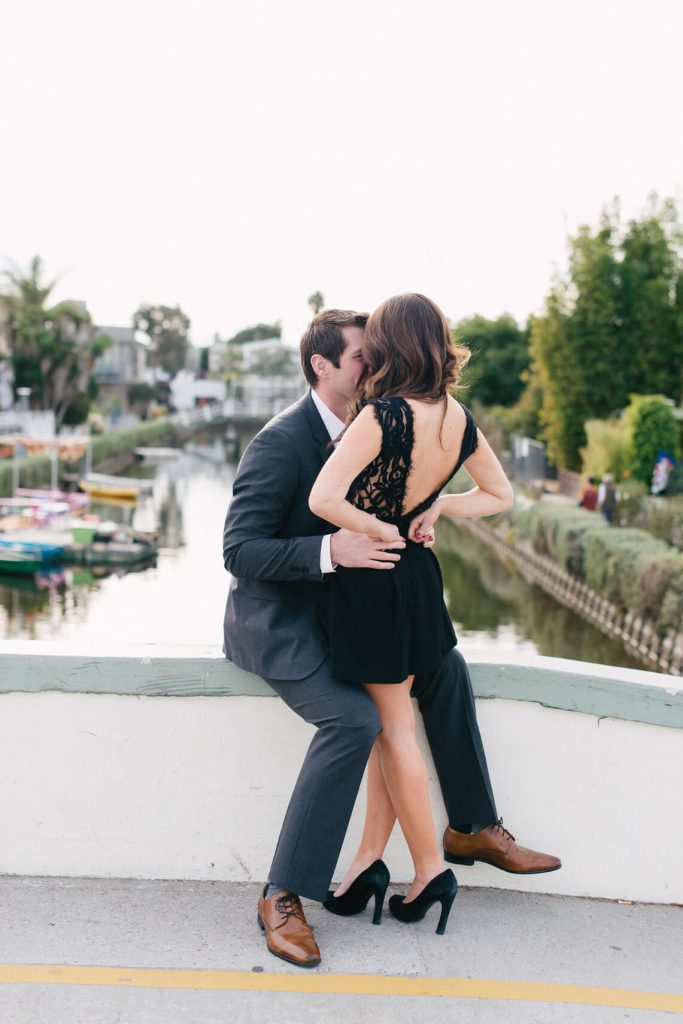 couple kiss on bridge venice canals engagement shoot