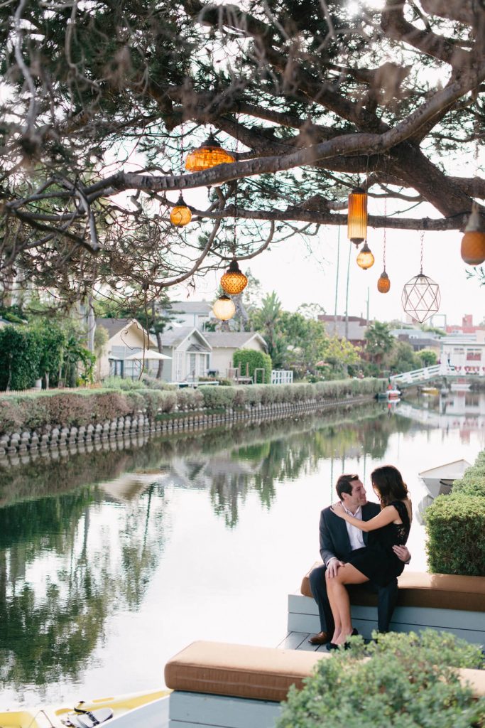 couple embracing near water venice canals engagement photos