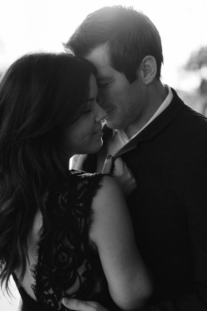 moody black and white couple embracing 