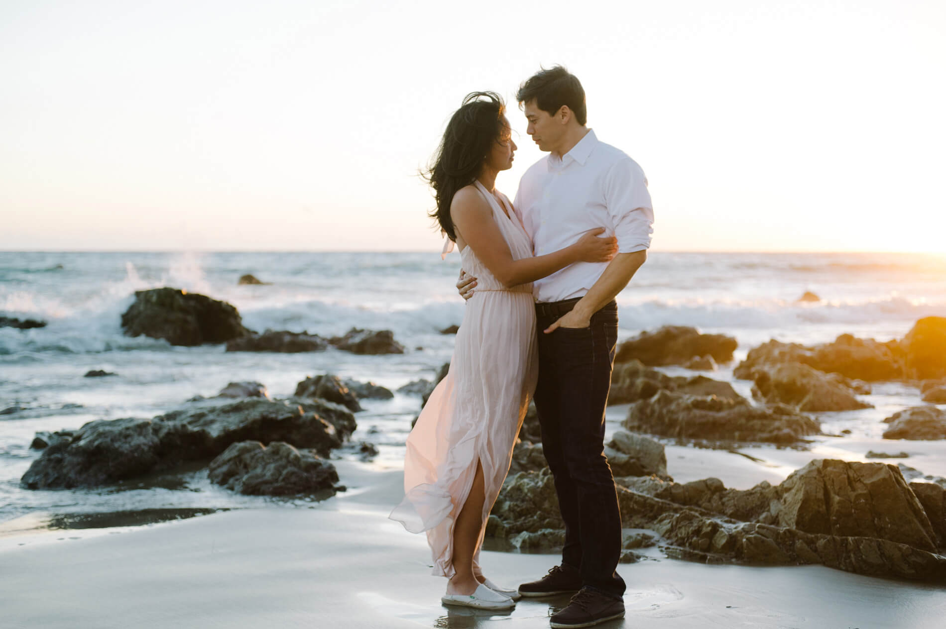 couple embracing at el matador beach malibu engagement photo
