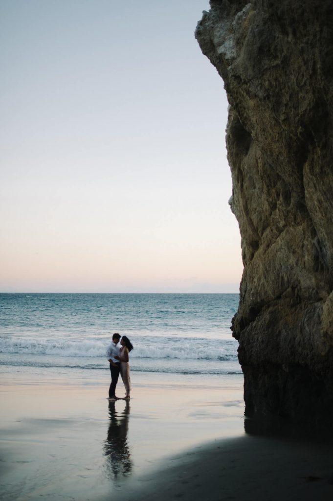 couple posing at sunset el matador beach malibu engagement