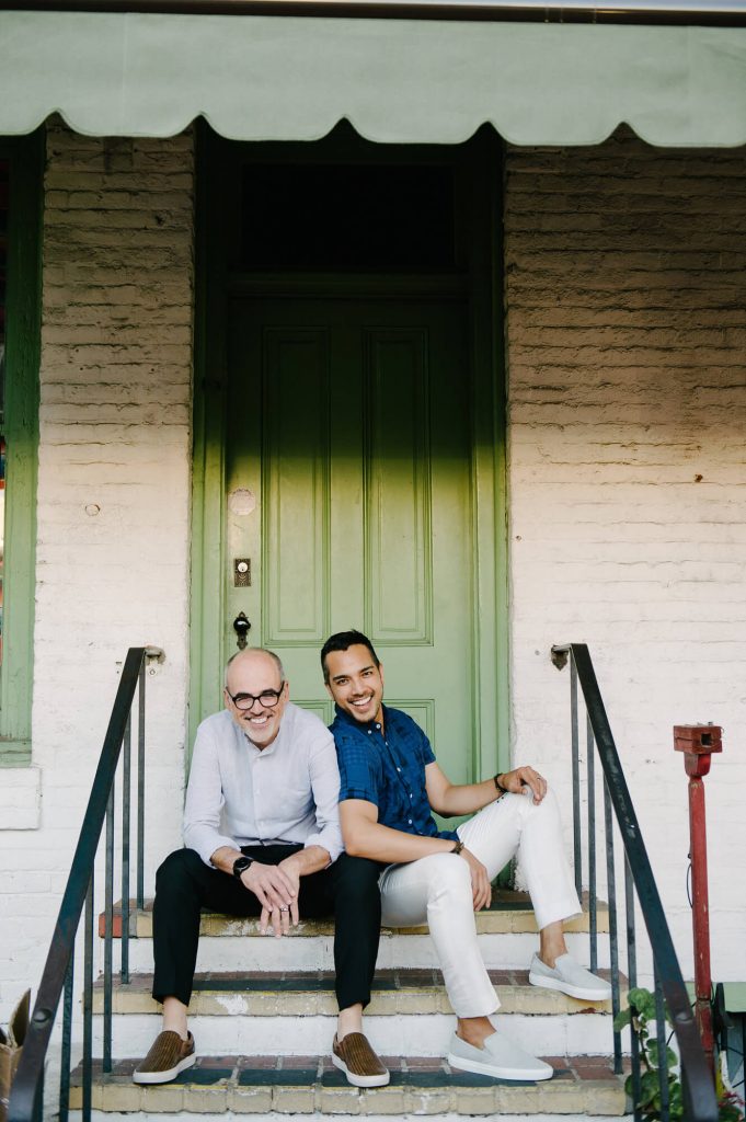 gay couple pose on steps olvera street engagement shoot