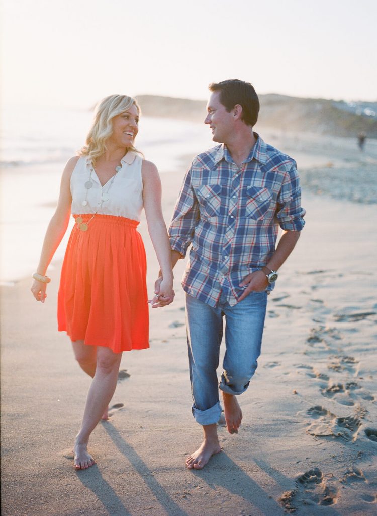 couple walking holding hands crystal cove engagement photo