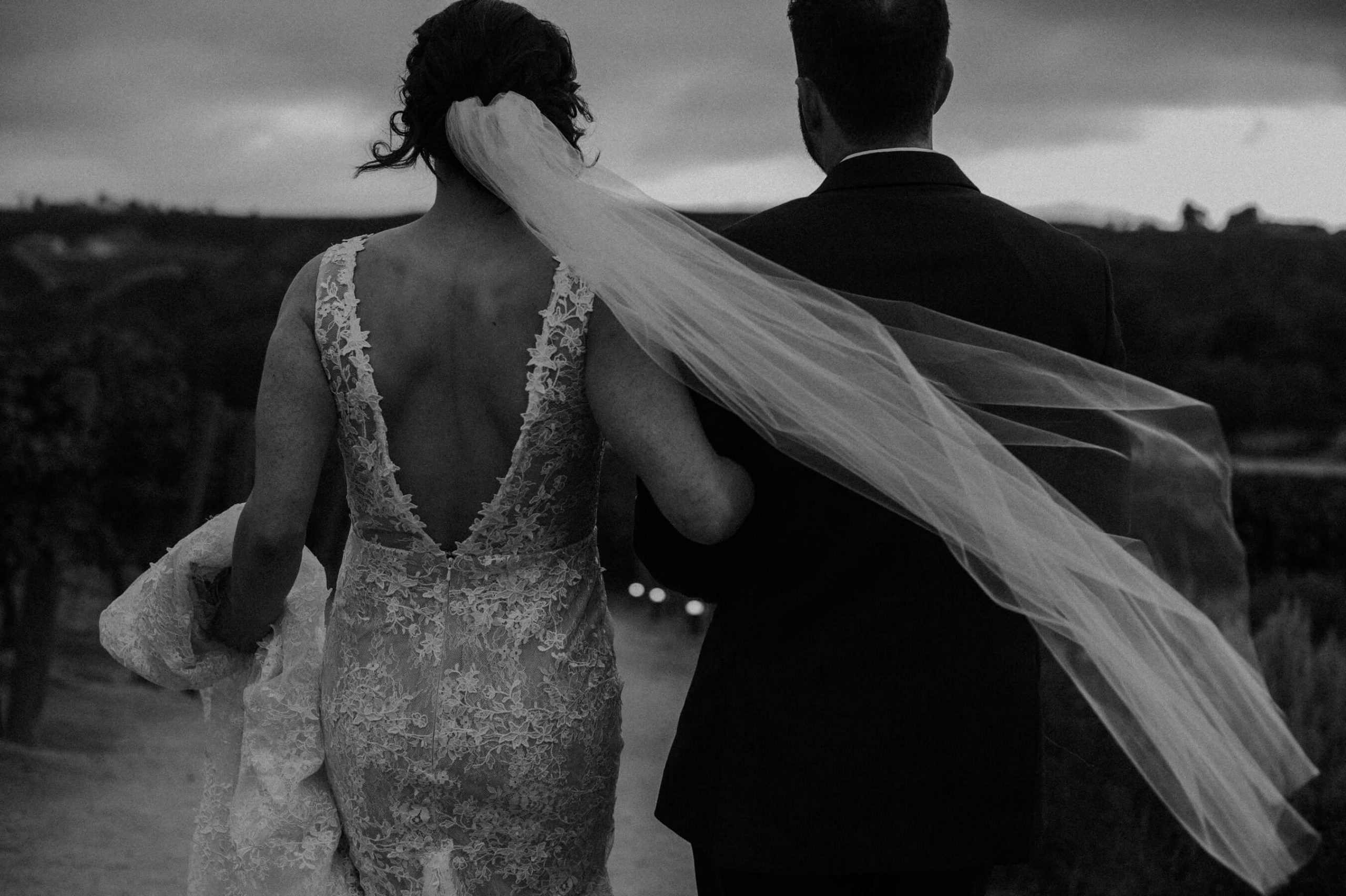 brides veil catches wind black and white