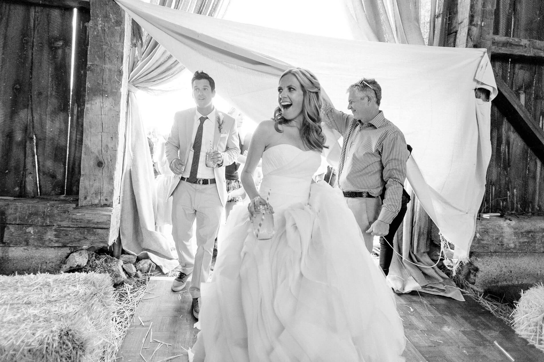 bride and groom reacting with joy seeing rustic barn decor first time