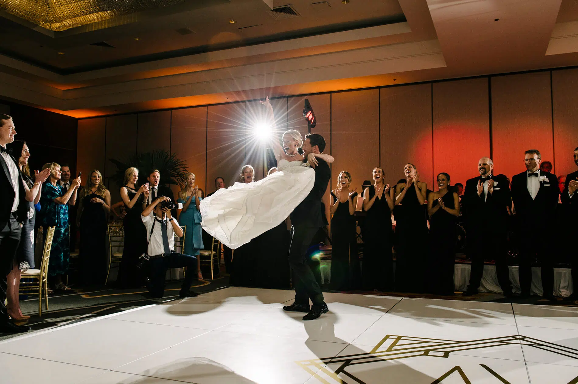 groom picking up bride and spinning on dance floor at hilton la jolla torrey pines shot by experienced wedding photographer