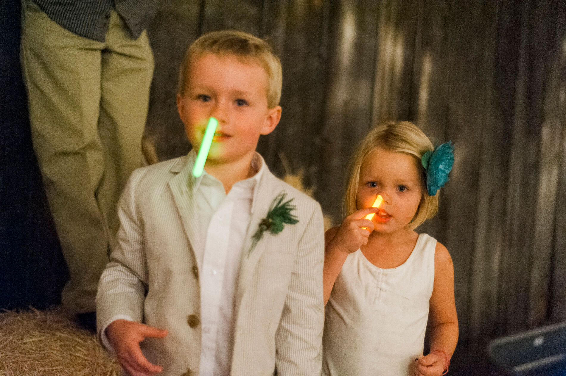 ring bearer and flower girl shoving glow sticks in noses