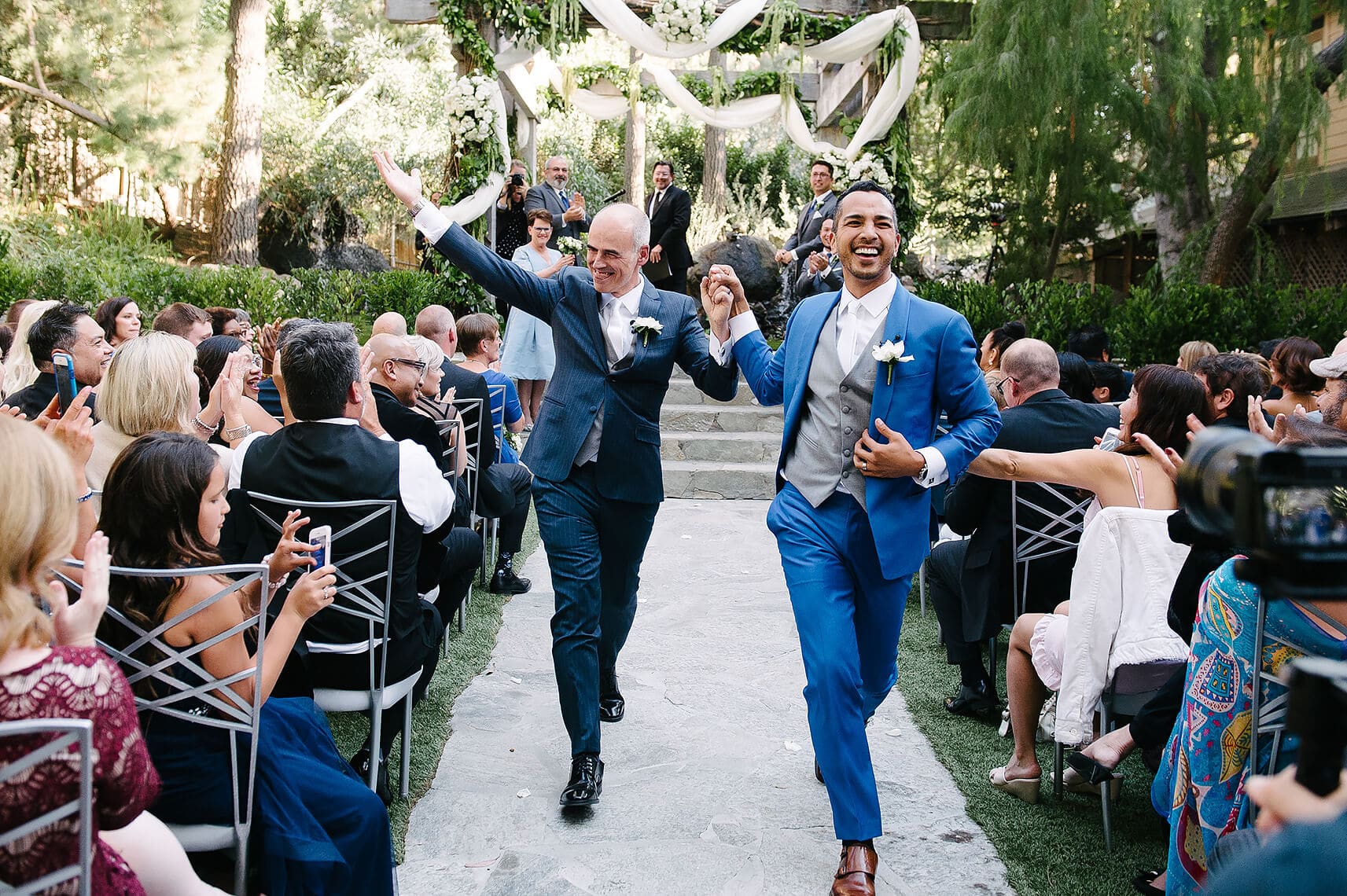 two grooms process down aisle during their same sex ceremony for calamigos ranch malibu wedding