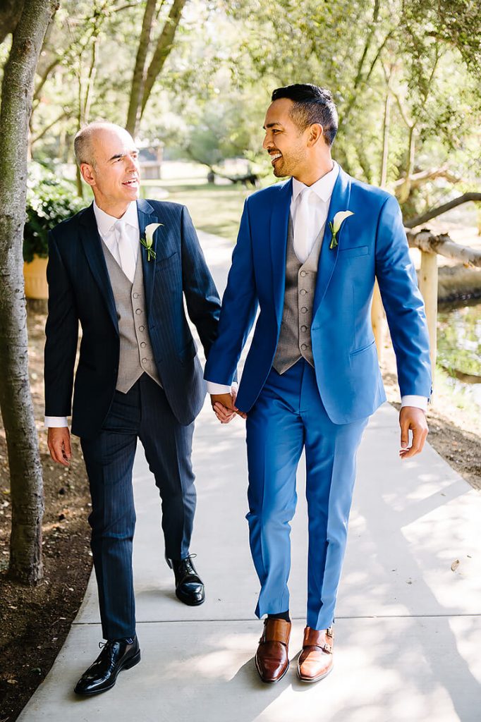 two grooms walking holding hands calamigos ranch wedding