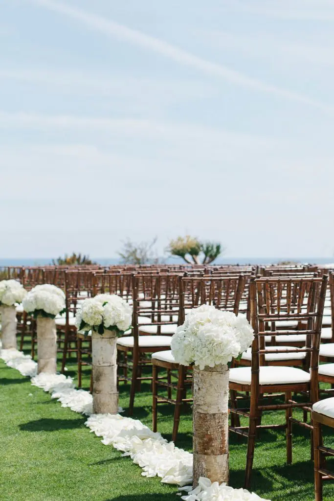 white flowers on wooden logs montage laguna beach wedding ceremony