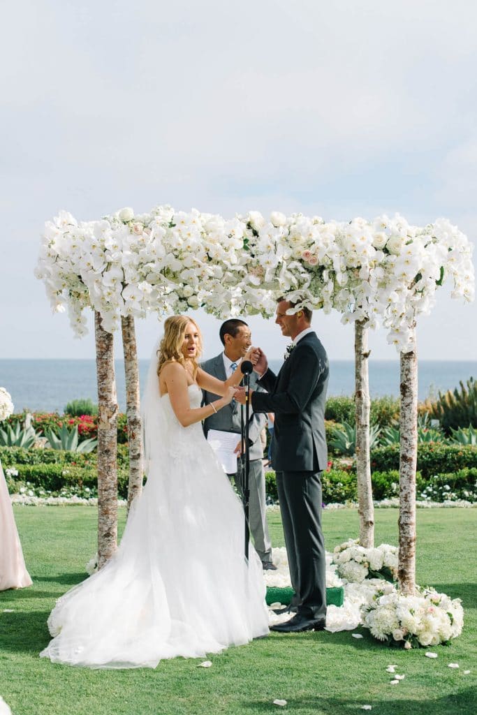 bride laughing after kissing groom montage laguna beach