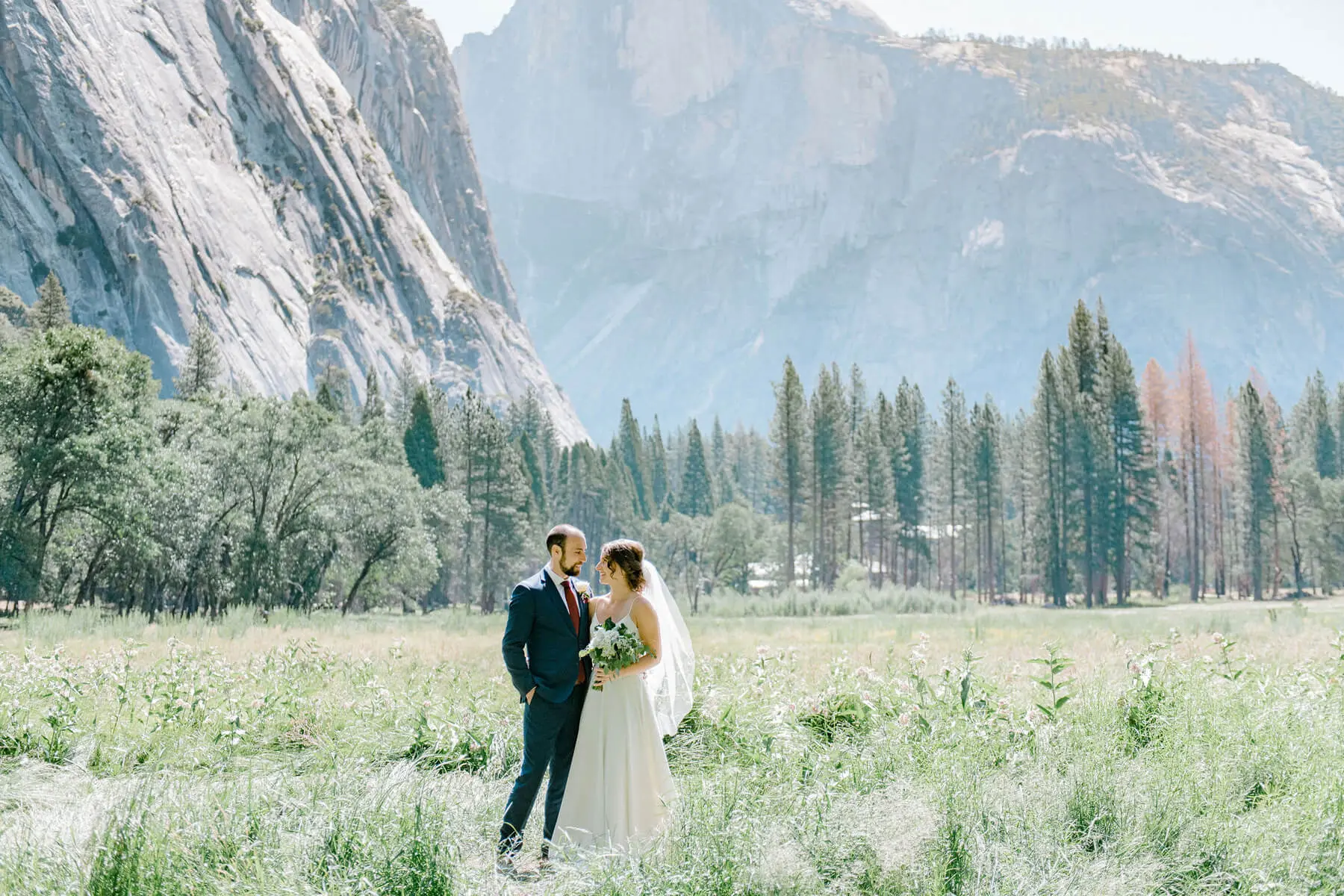 bride and groom posing in ahwahnee meadow with halfdome in background yosemite adventure elopement