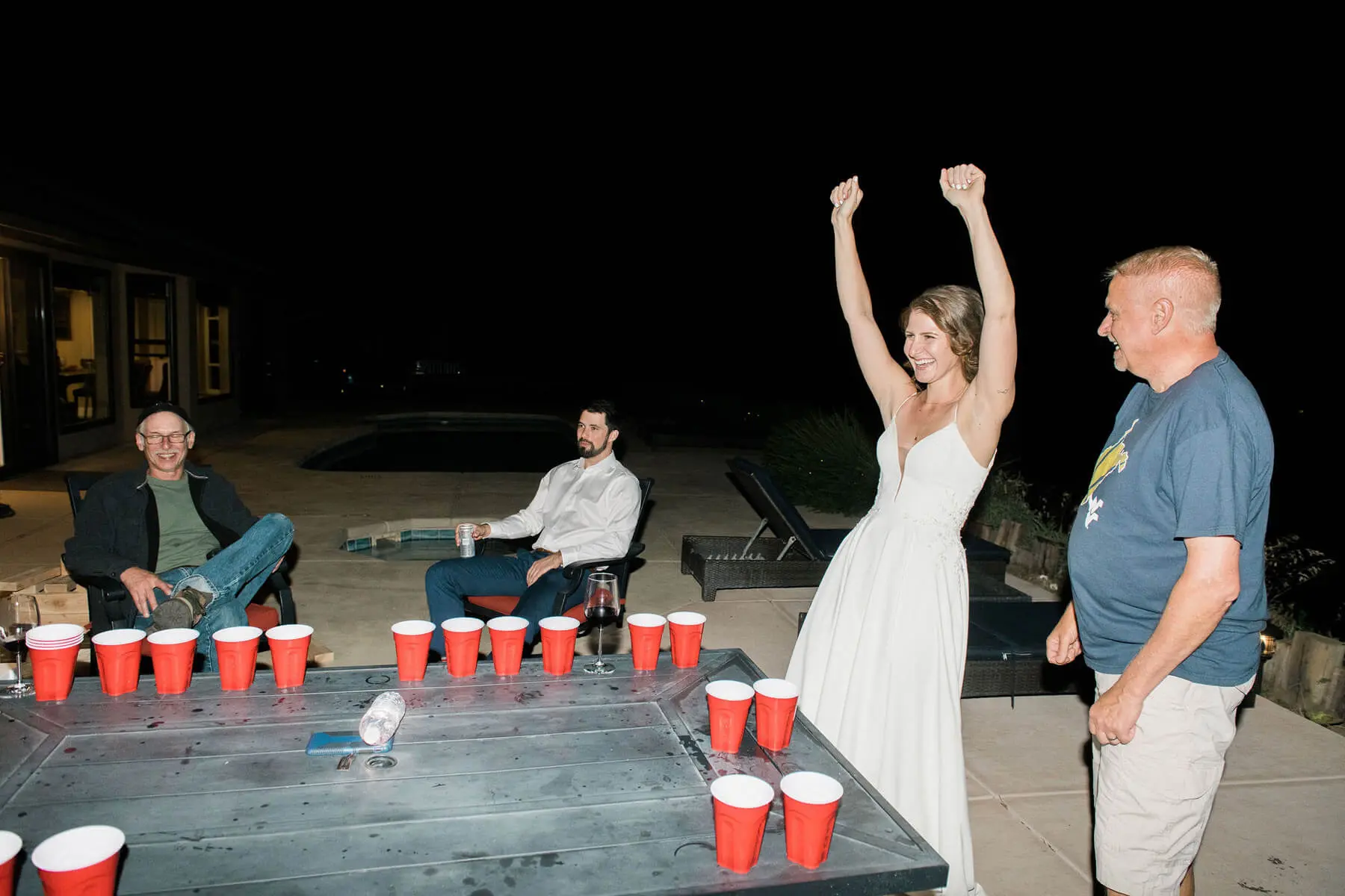 bride and father react to winning game of beer pong 